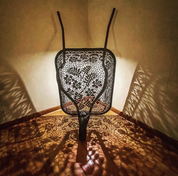A chair with a shadow on it in a dark room.