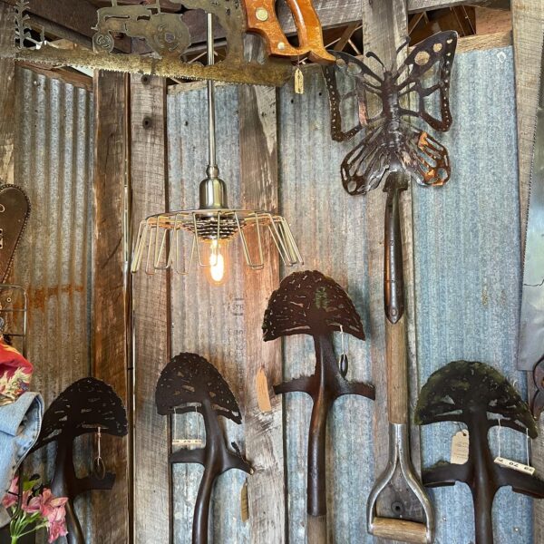 A display of old garden tools and a lamp.