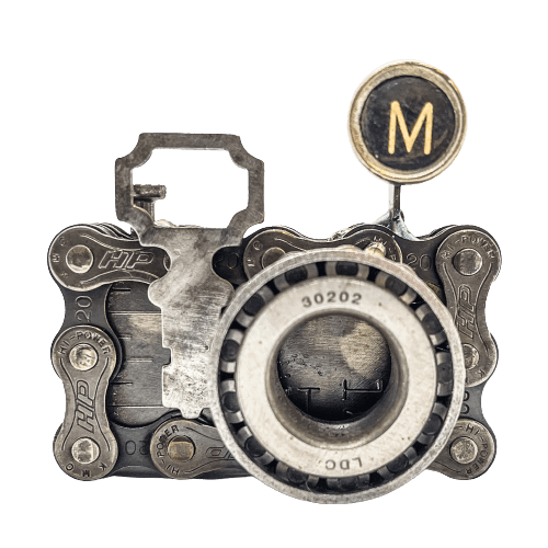 A steampunk camera with the letter m on it.