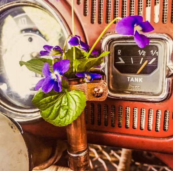 A car with a Magnetic Copper Bud Vase on the dashboard.