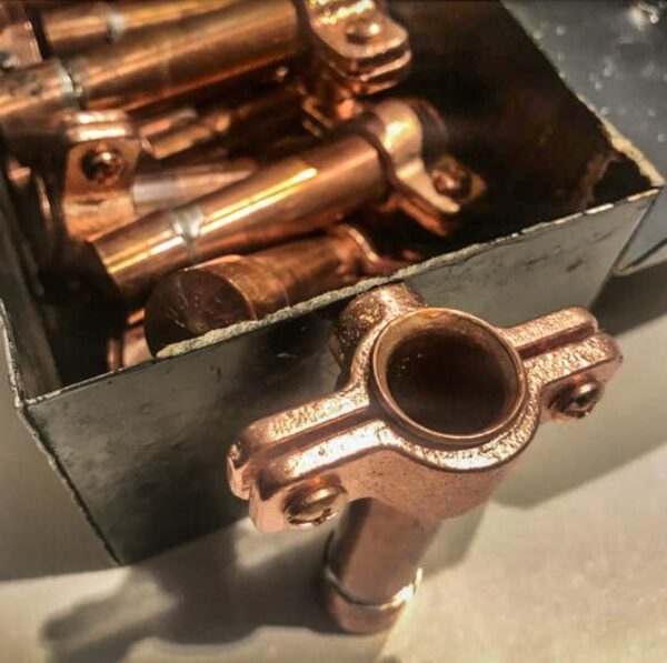 Magnetic Copper Bud Vase fittings in a box on a table.