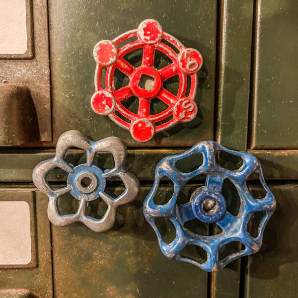 Three Shut-Off Valve Knob Magnets (set of 3) on a green cabinet.
