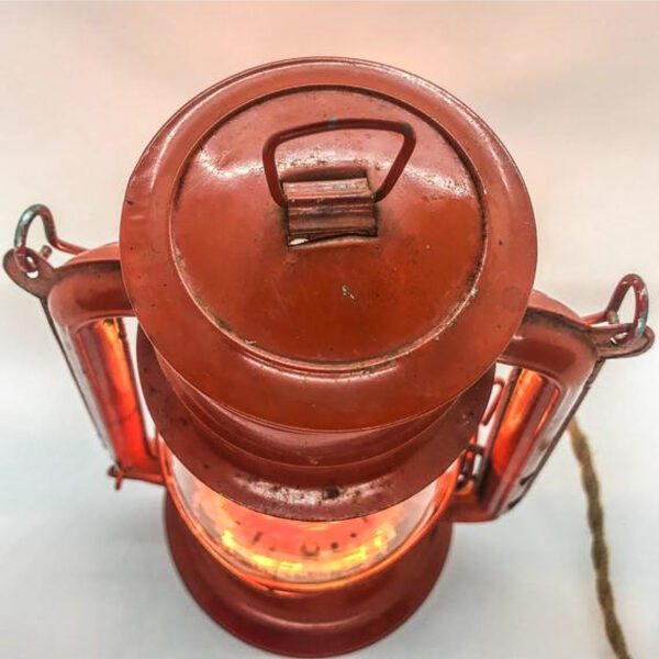A Vintage Lantern converted to Desk Lamp with a red light on it.