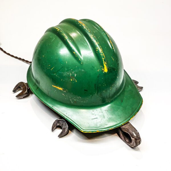 A green hard hat with Turtle Lamp on it.