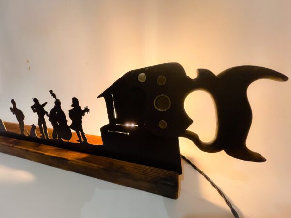 A lamp with silhouettes of people on it.