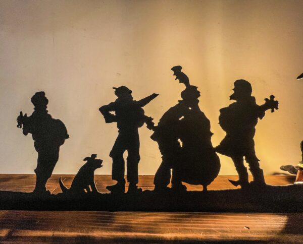 Silhouettes of a group of people on a shelf.