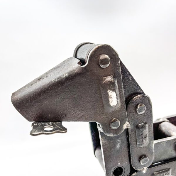 A close up of a "JunkYard" Dog latch on a white background.