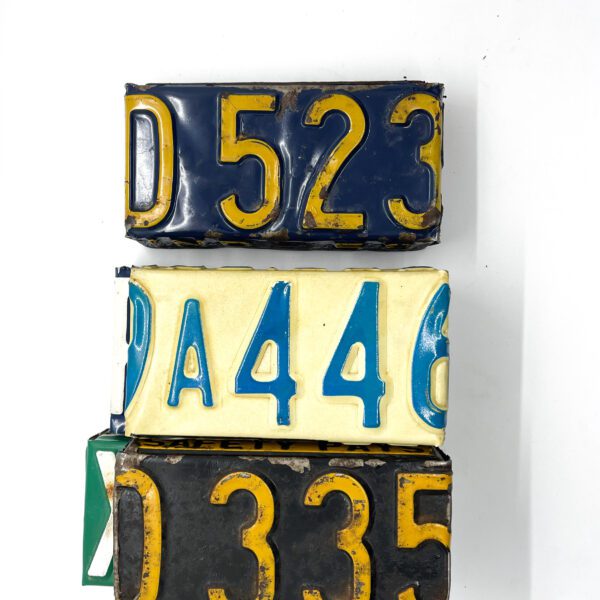 A Vintage License Plate Valet Tray stacked on top of each other.