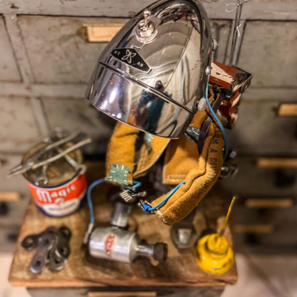 A helmet and tools are sitting on top of a wooden table.
