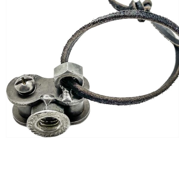 A silver bracelet with a nut and bolt on it.
