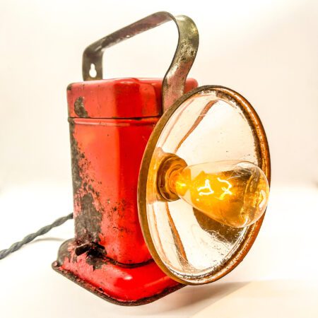 A Small (handheld) Vintage Lantern Lamp with a bulb on it.