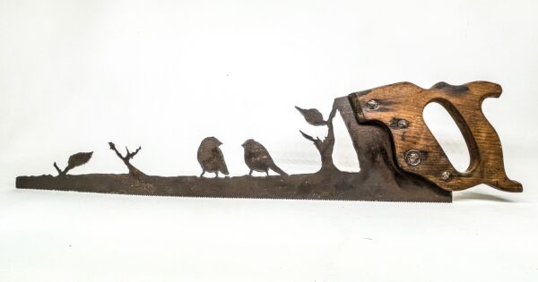 A metal sculpture of a plasma cut saw-love birds on tree branch.