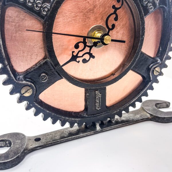 A Copper Clock from salvaged materials with gears on it.