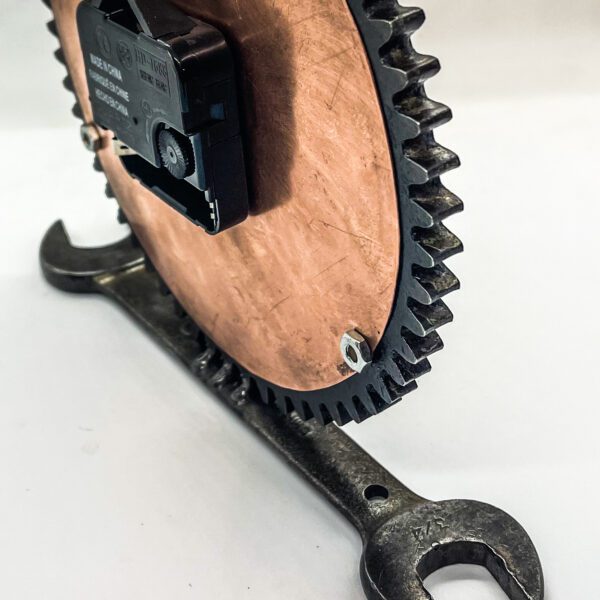 A Copper Clock from salvaged materials with a gear on it.